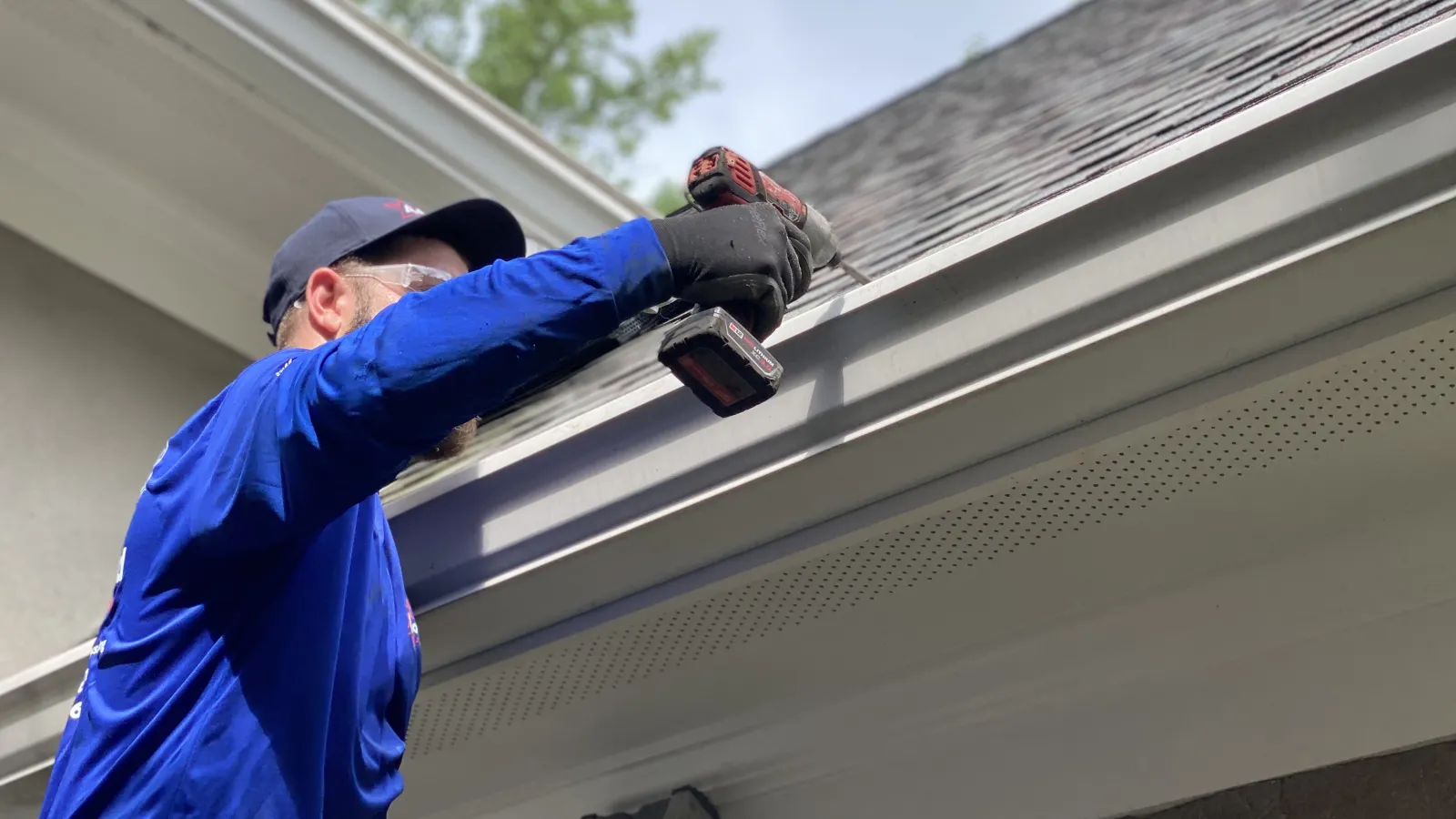 Roofing crew applying underlayment and flashing during residential install