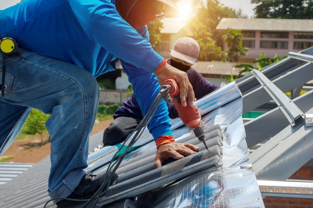 Roofing crew applying underlayment and flashing during residential install