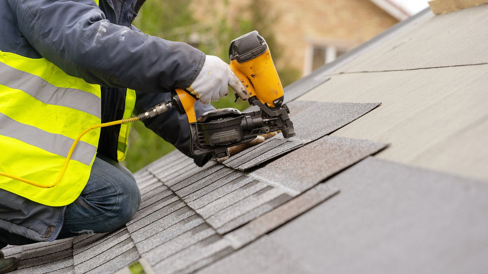 Roofing crew applying underlayment and flashing during residential install