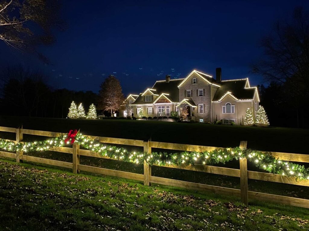 Professional Christmas light installer decorating a roofline in Tarrant County, TX