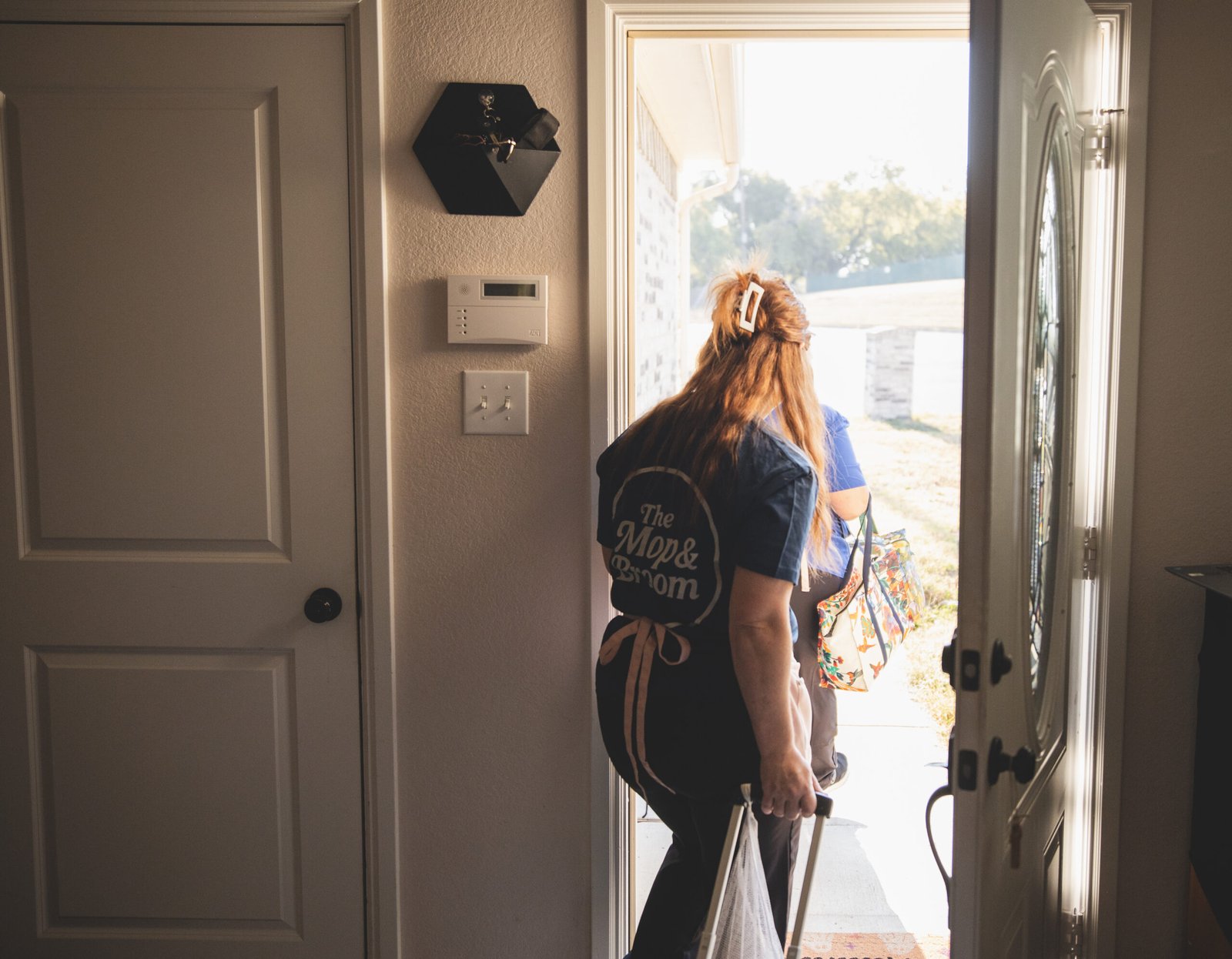 Professional cleaner from The Mop & Broom entering a home in Haltom-City for cleaning services