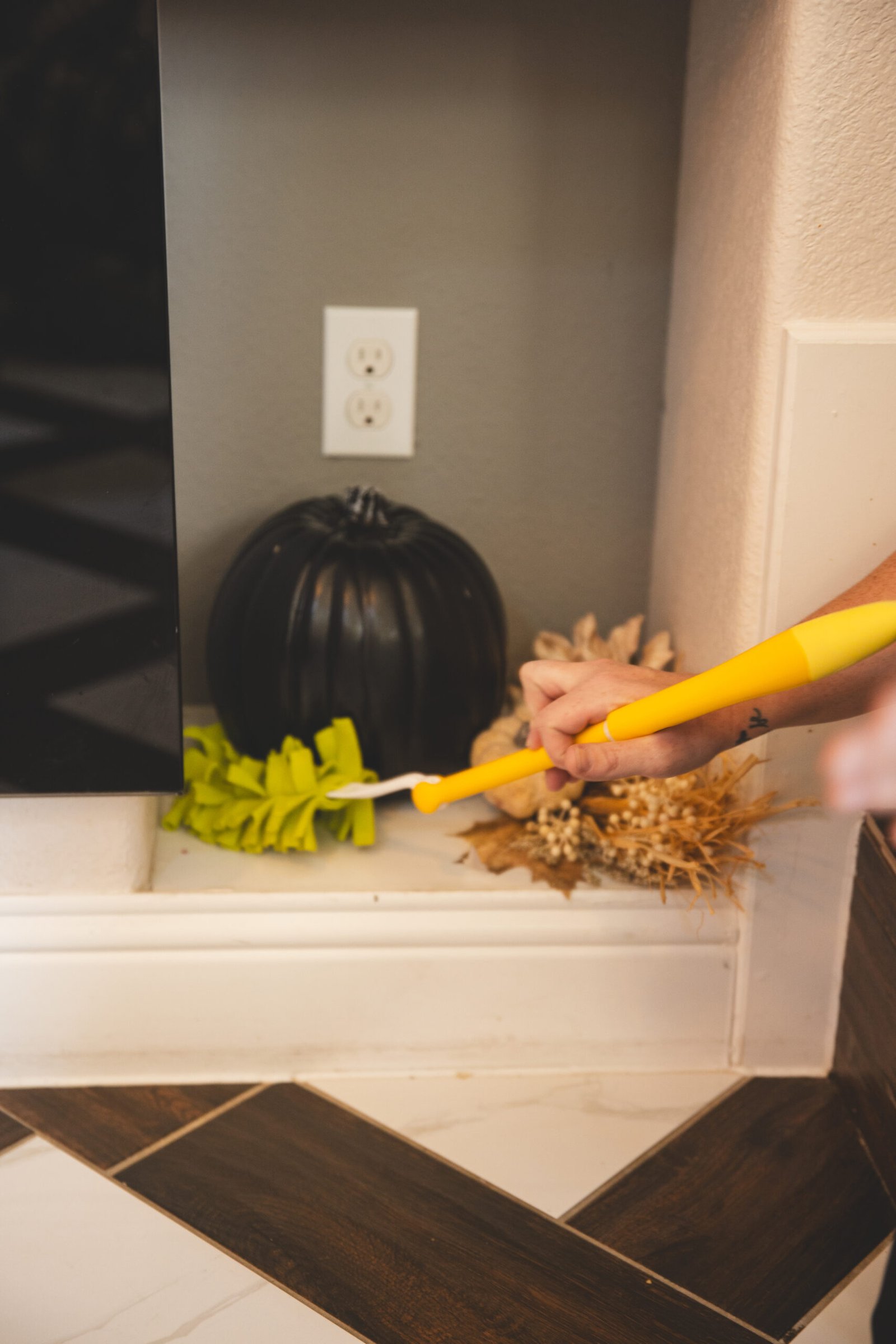 Service near me by The Mop & Broom, showing a person cleaning around decorations in Lake Worth.