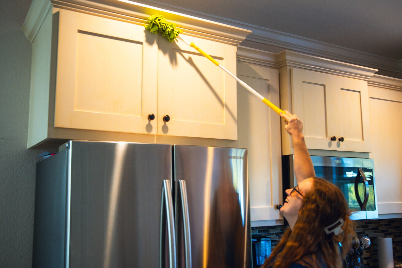Person using a sponge to deep-clean a shower glass near Flower Mound, TX with The Mop & Broom