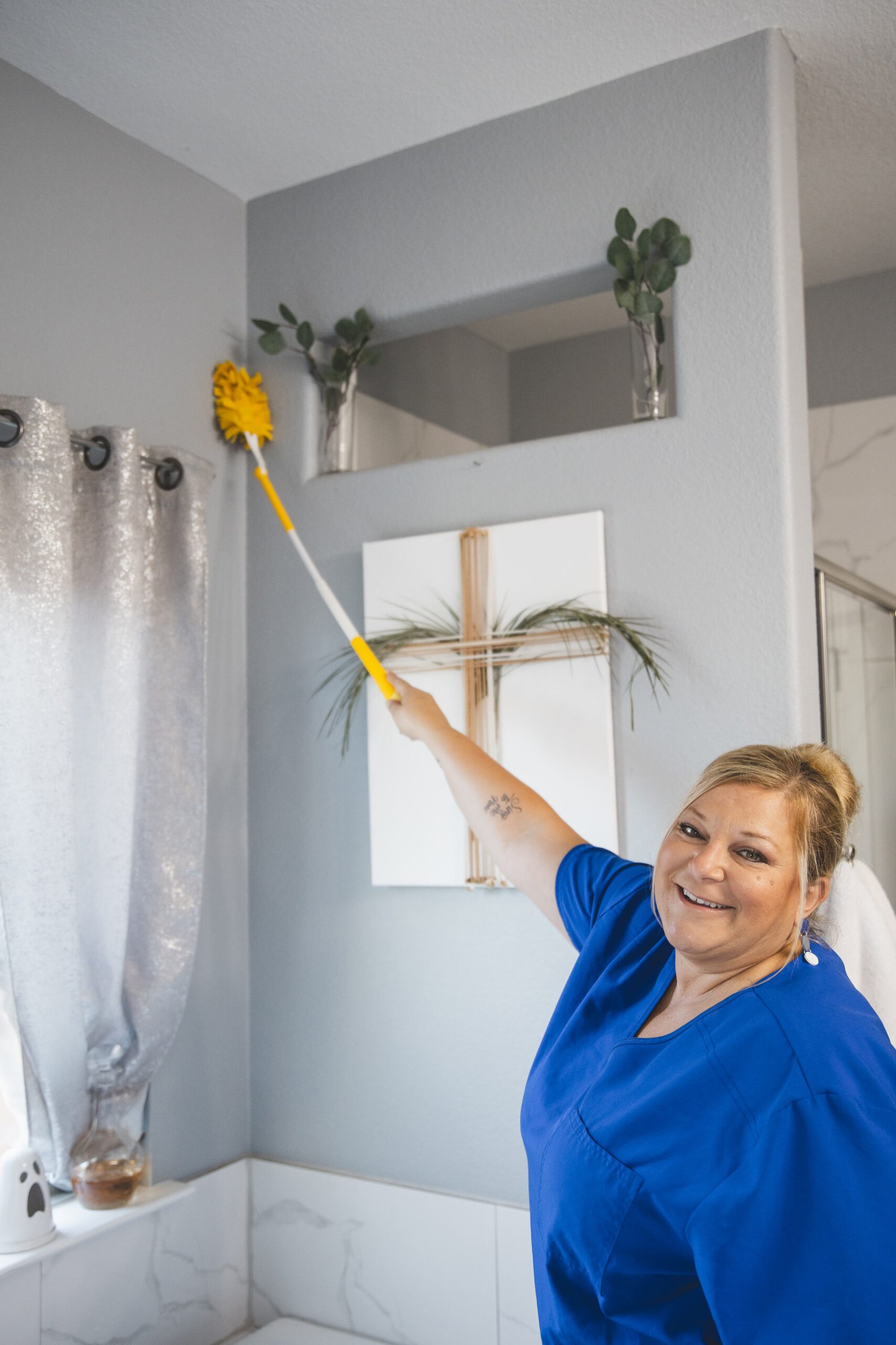 House cleaning service near me by The Mop & Broom in Flower Mound, TX, featuring a cleaner spraying disinfectant on a countertop.