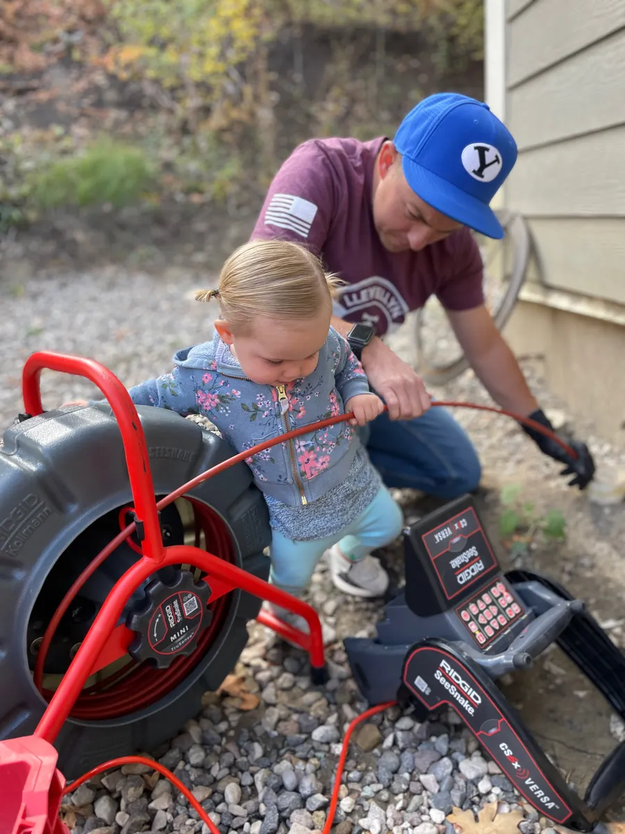 Llewellyn plumber using a drain cleaning machine