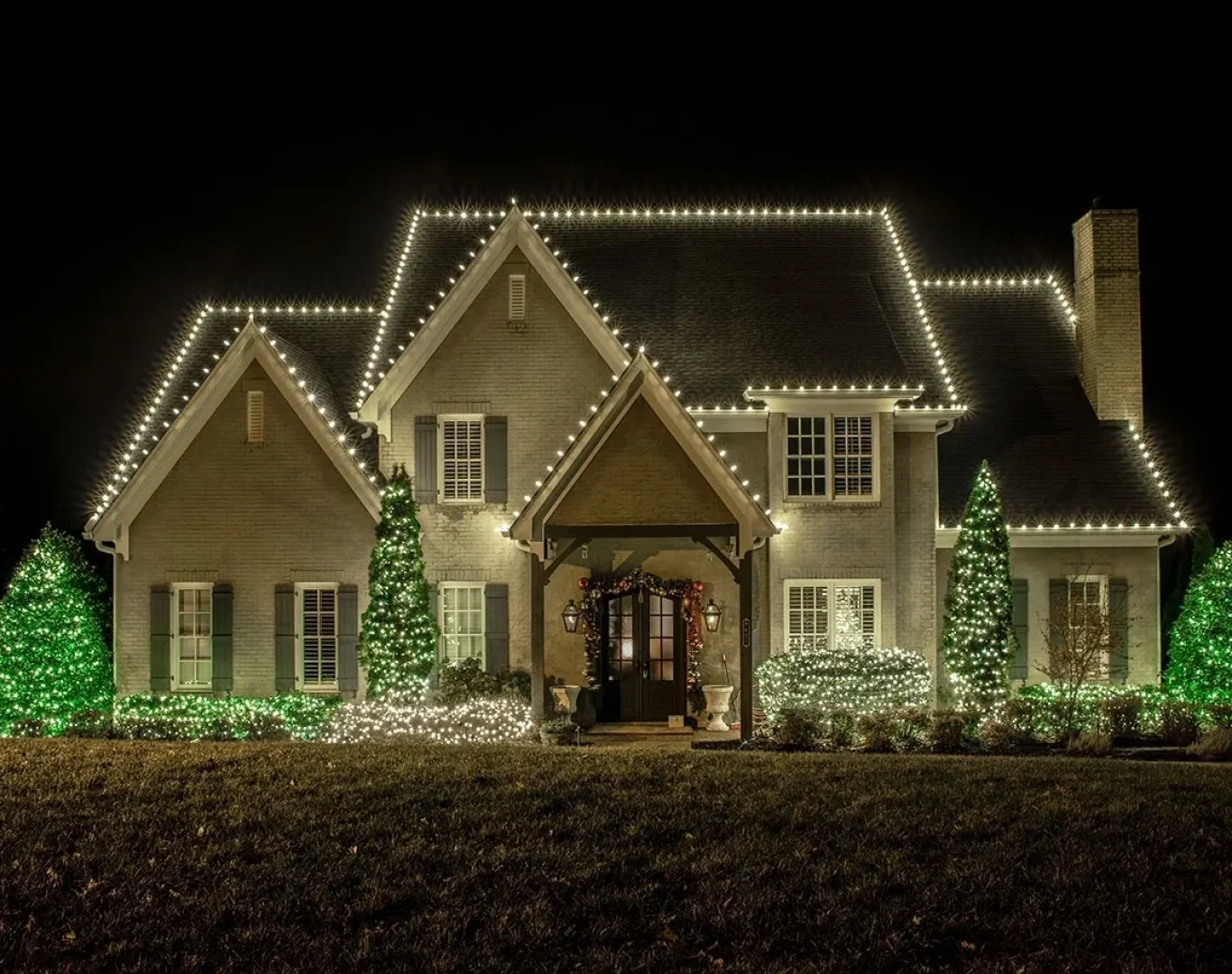 Team carefully removing lights from a residential roof after the season